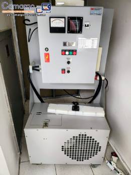 Automatic stainless steel induction lid sealer for GRC jars and bottles.